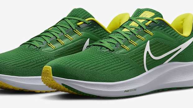 Side view of green and yellow Nike running shoes.